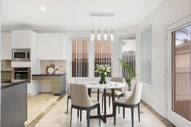 dining room featuring crown molding