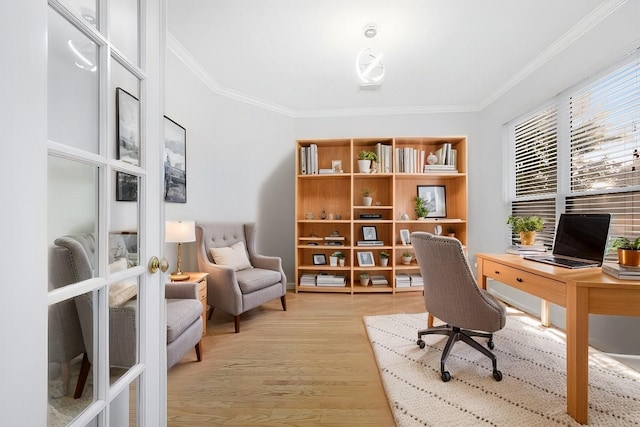 home office featuring ornamental molding and light wood-type flooring