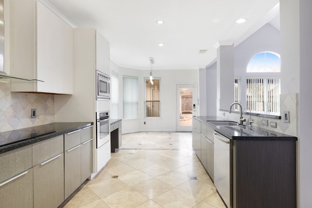 kitchen featuring pendant lighting, sink, backsplash, and stainless steel appliances