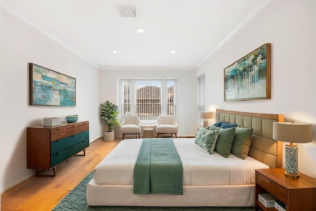 bedroom featuring ornamental molding and light wood-type flooring