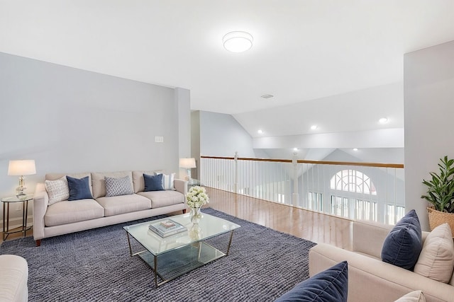 living room with vaulted ceiling and hardwood / wood-style floors