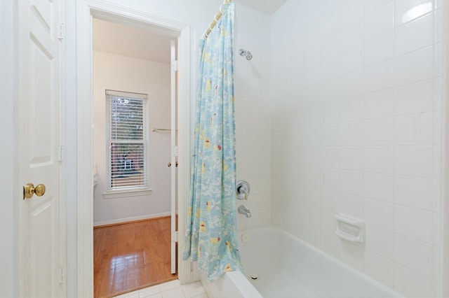 bathroom featuring shower / tub combo and hardwood / wood-style floors