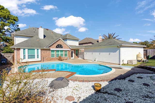 view of swimming pool featuring a diving board and a patio area