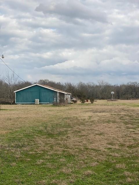 view of yard with a rural view