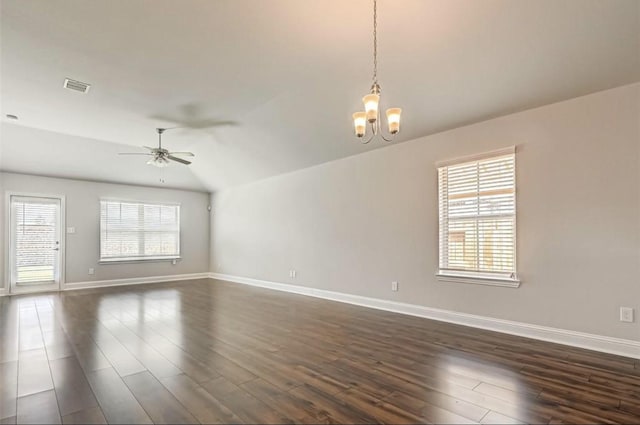 spare room with lofted ceiling, a healthy amount of sunlight, and dark wood-type flooring