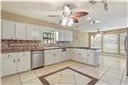 kitchen featuring ceiling fan and white cabinets