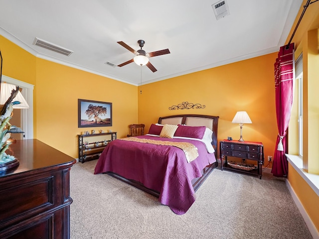 carpeted bedroom featuring crown molding and ceiling fan