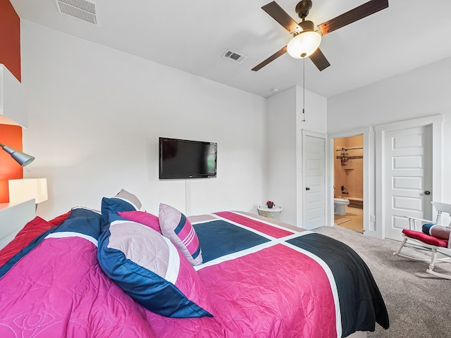 carpeted bedroom with connected bathroom and ceiling fan