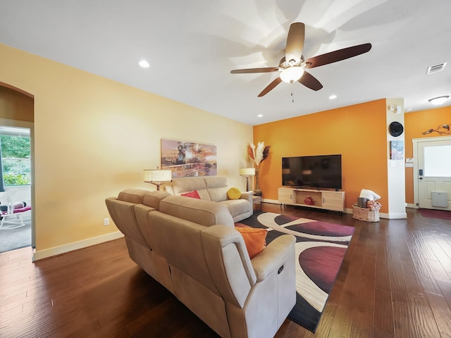 living room with dark hardwood / wood-style floors and ceiling fan