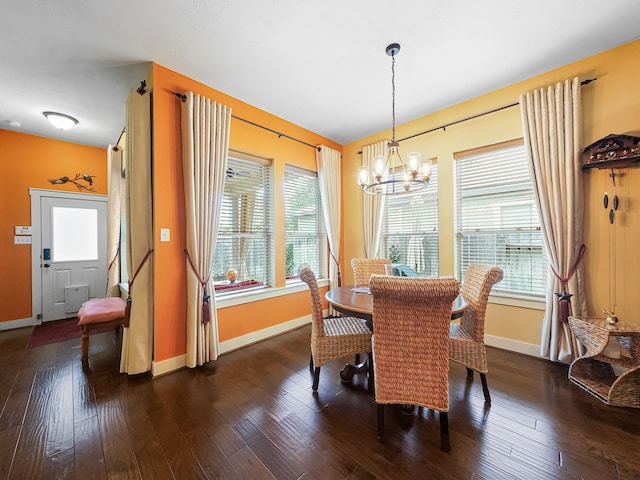 dining room featuring plenty of natural light, dark hardwood / wood-style floors, and an inviting chandelier