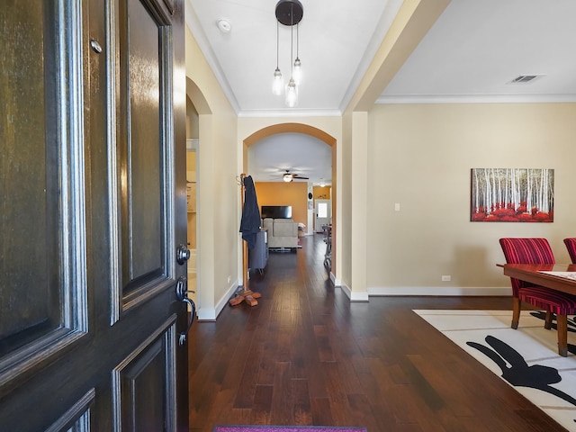 entryway featuring dark hardwood / wood-style flooring, ornamental molding, and ceiling fan