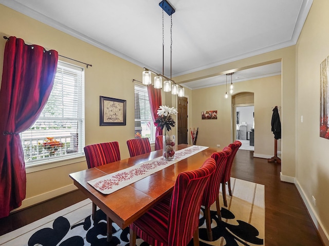 dining room featuring crown molding and dark hardwood / wood-style flooring