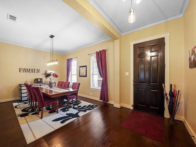 entrance foyer with crown molding and dark hardwood / wood-style floors