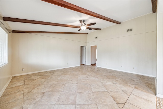 empty room with ceiling fan, lofted ceiling with beams, and light tile patterned floors