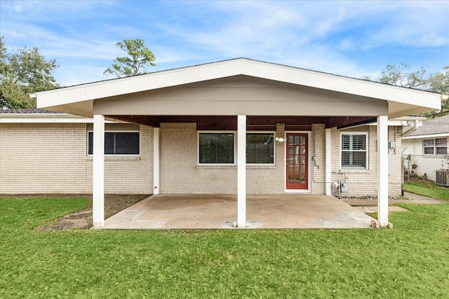 back of house with cooling unit, a patio, and a lawn