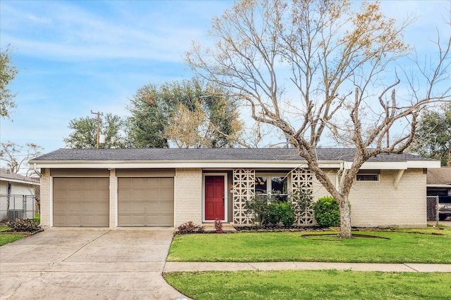 ranch-style home with a garage and a front lawn