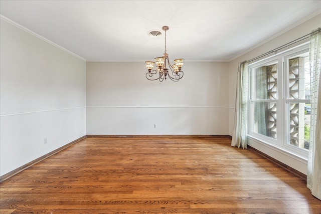 interior space with wood-type flooring, plenty of natural light, a notable chandelier, and crown molding