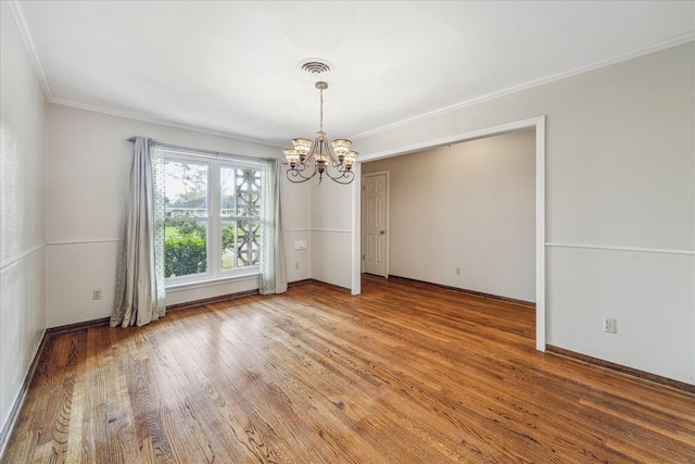 unfurnished dining area with an inviting chandelier, hardwood / wood-style flooring, and crown molding