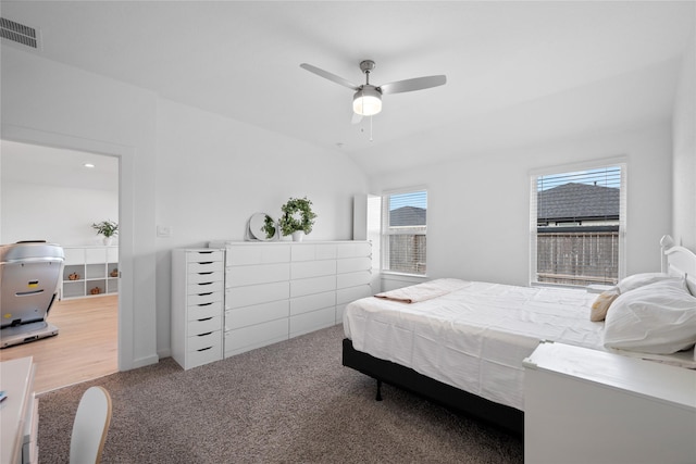 bedroom with lofted ceiling, ceiling fan, and carpet flooring