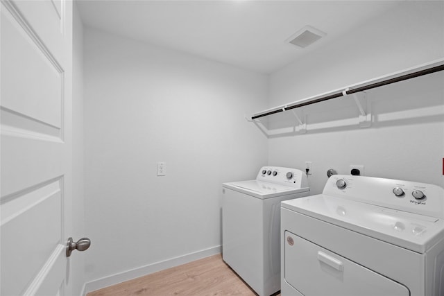 laundry room featuring light hardwood / wood-style flooring and independent washer and dryer