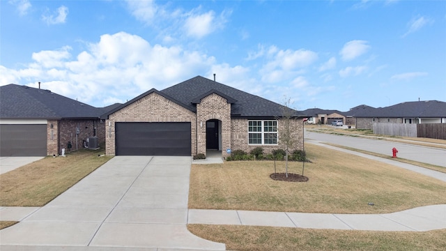 view of front facade featuring central AC, a garage, and a front lawn