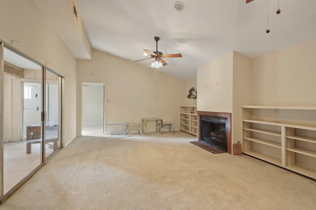 unfurnished living room with ceiling fan, lofted ceiling, and carpet floors