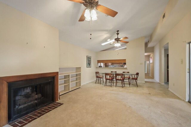 dining area with vaulted ceiling, ceiling fan, and carpet