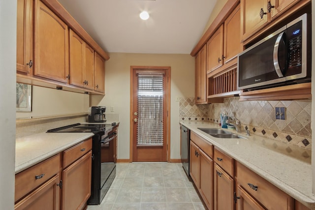 kitchen with sink, backsplash, stainless steel appliances, light stone counters, and light tile patterned flooring