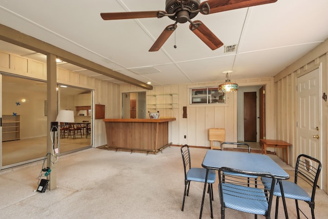 dining room with light carpet and ceiling fan