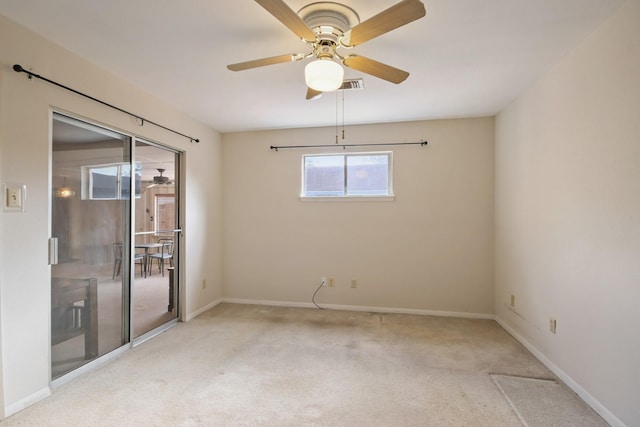 empty room featuring light carpet and ceiling fan