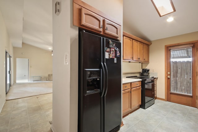 kitchen with lofted ceiling and black appliances