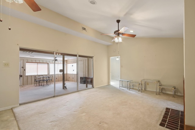 carpeted spare room featuring high vaulted ceiling and ceiling fan