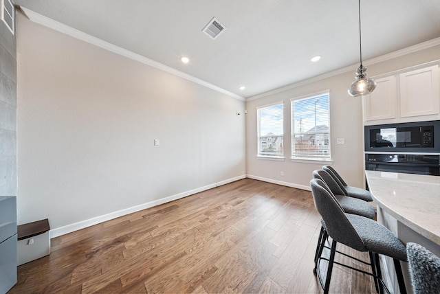 home office with crown molding and wood-type flooring