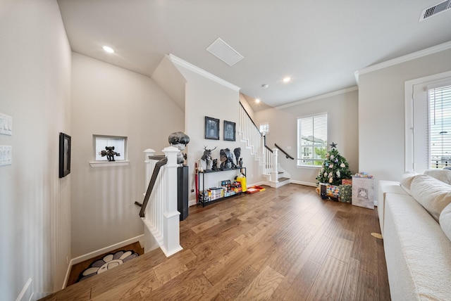 interior space with crown molding and wood-type flooring