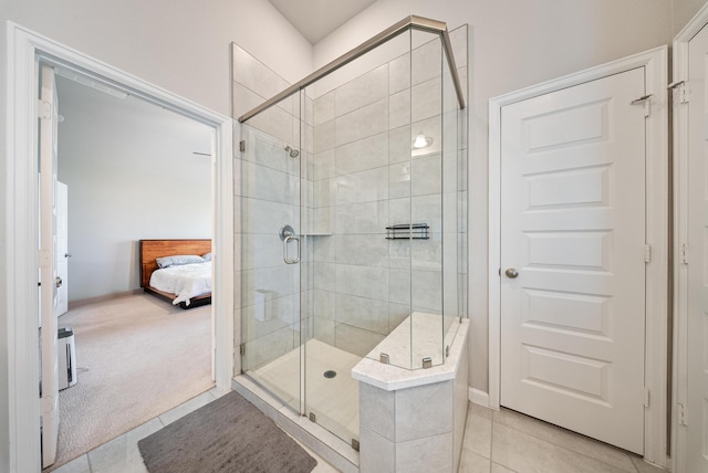 bathroom with tile patterned flooring and a shower with shower door