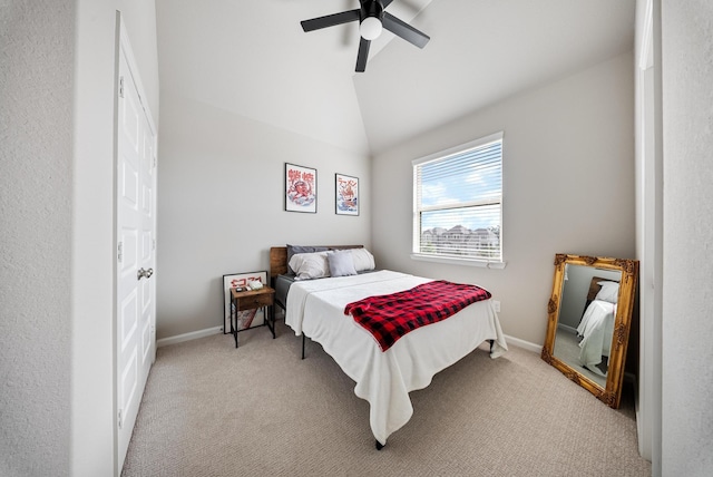 bedroom featuring vaulted ceiling, light colored carpet, and ceiling fan