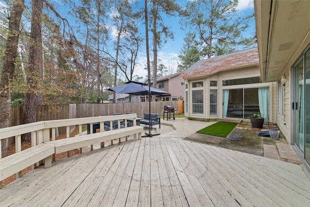 wooden terrace featuring area for grilling and a patio area