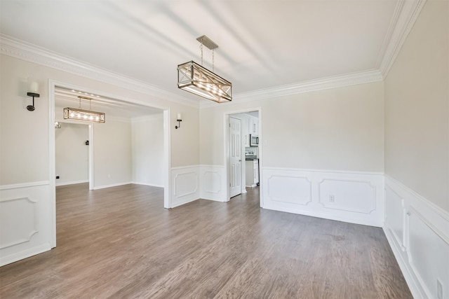 unfurnished room featuring crown molding and wood-type flooring