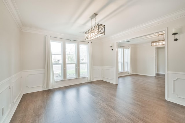 empty room featuring dark wood-type flooring and crown molding