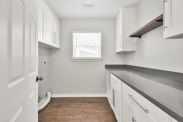 clothes washing area with cabinets, dark hardwood / wood-style floors, and electric dryer hookup