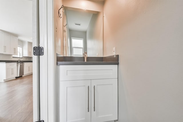 bathroom featuring wood-type flooring and sink