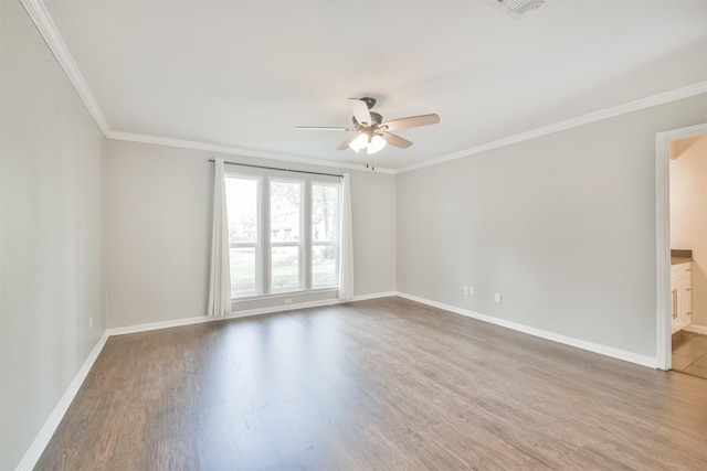 spare room with hardwood / wood-style floors, crown molding, and ceiling fan