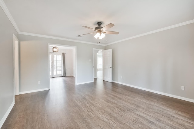 unfurnished room featuring dark hardwood / wood-style flooring, ornamental molding, and ceiling fan