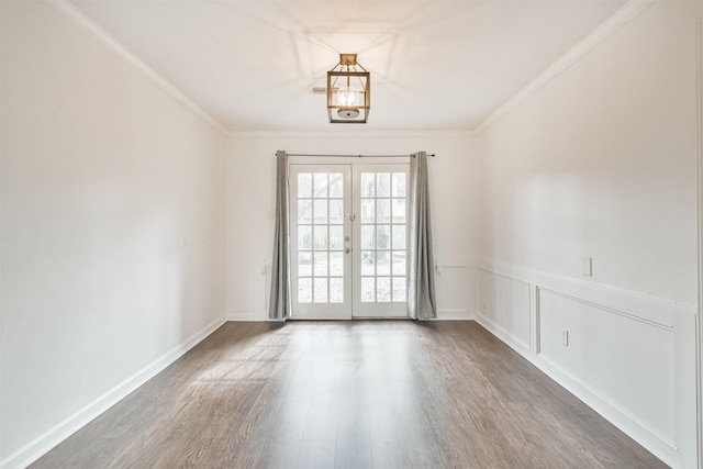 unfurnished room featuring crown molding, dark hardwood / wood-style flooring, and french doors