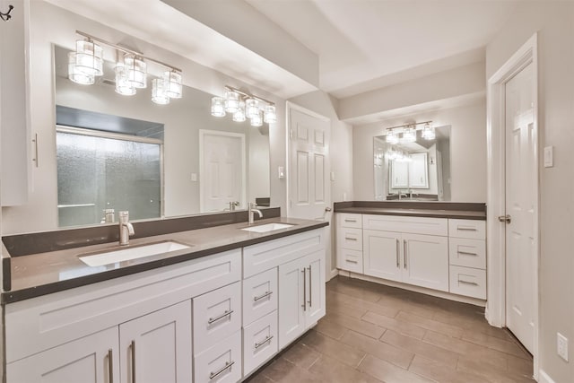 bathroom featuring vanity and an enclosed shower