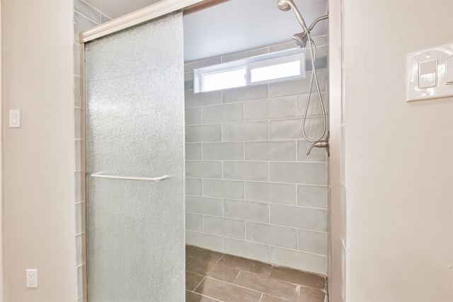 bathroom featuring a shower with door