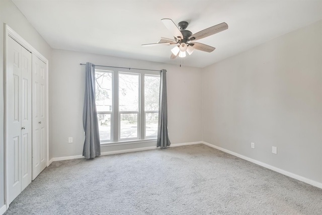 unfurnished room featuring ceiling fan and carpet