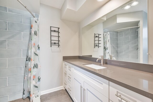 bathroom with vanity, curtained shower, and tile patterned floors