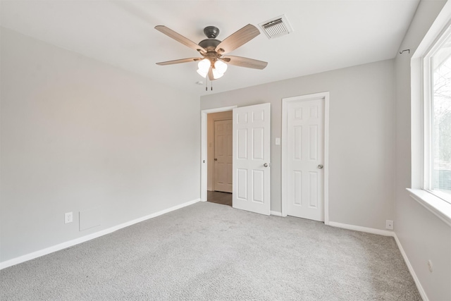 unfurnished bedroom with ceiling fan and carpet