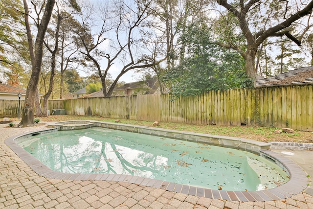 view of swimming pool with an in ground hot tub